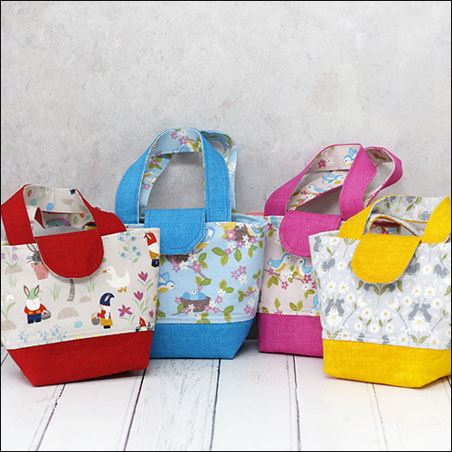 Collection of 4 child's toy tote bags in different prints
