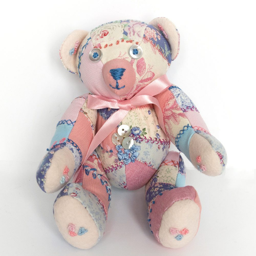 Collectible patchwork teddy bear decorated with buttons and embroidery