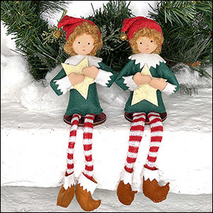 Pair of elves clutching stars sitting on a shelf