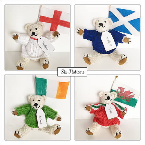 miniature hand knitted teddy bears in national jumpers with flags